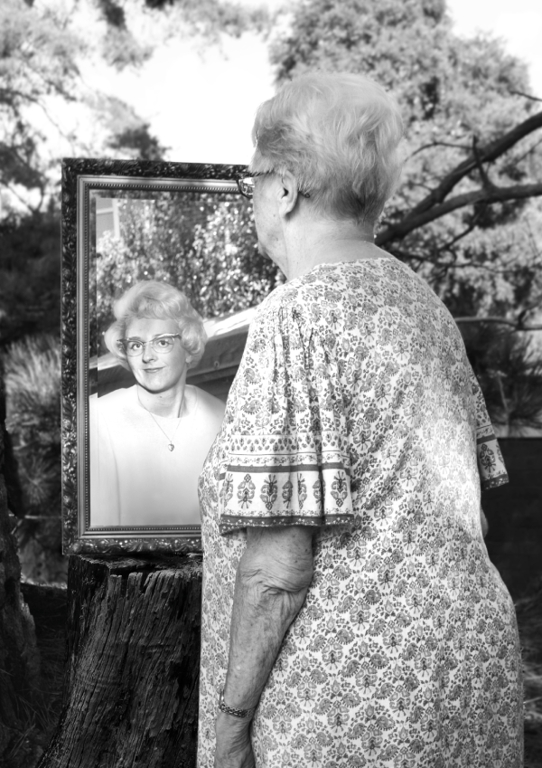 A person with a picture of their younger self