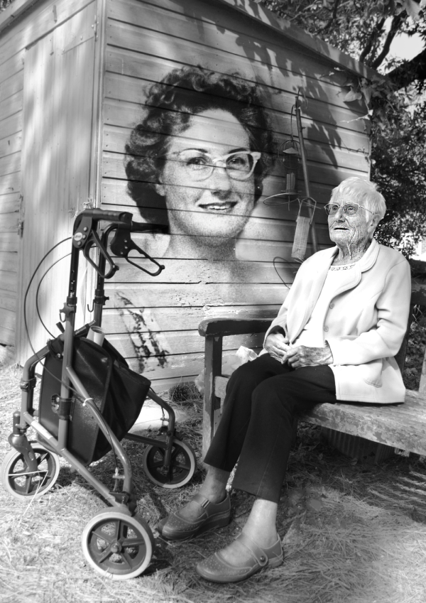 A person with a picture of their younger self